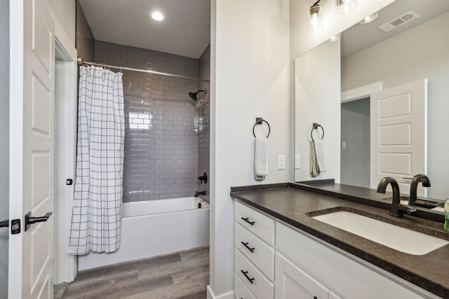 811 County Road 3451, Paradise, TX 76073 - bathroom with visible vents, shower / bath combo, wood finished floors, vanity, and recessed lighting