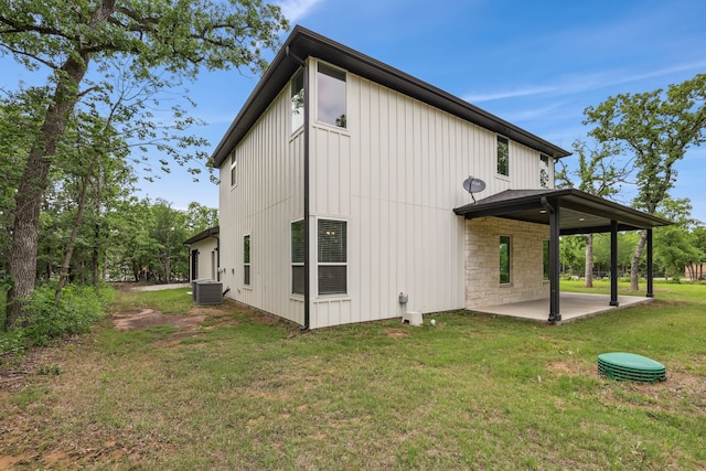 811 County Road 3451, Paradise, TX 76073 - rear view of house with a patio, board and batten siding, a yard, and cooling unit