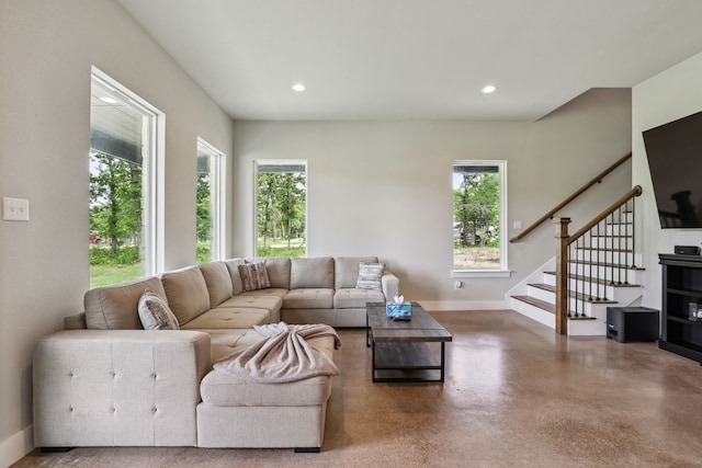811 County Road 3451, Paradise, TX 76073 - living area featuring stairs, concrete flooring, baseboards, and plenty of natural light