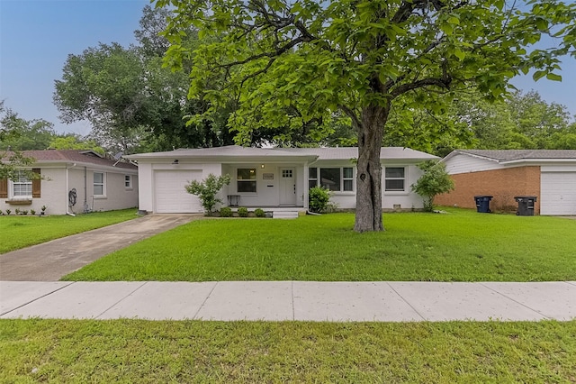 ranch-style house featuring covered porch, an attached garage, driveway, and a front yard