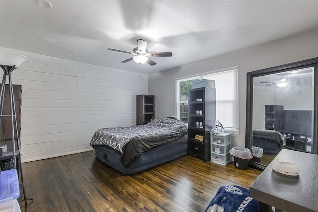 bedroom featuring a ceiling fan, a textured ceiling, and wood finished floors