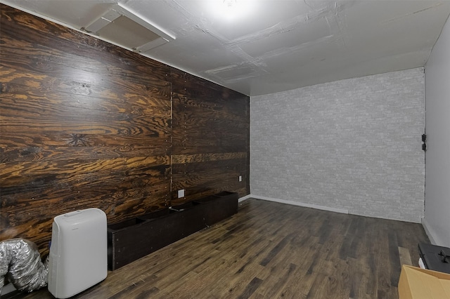 interior space with baseboards, attic access, and wood finished floors