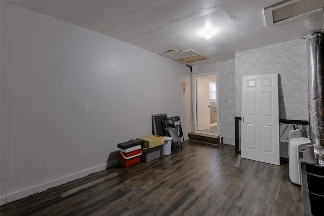 misc room with baseboards, attic access, and dark wood-style floors