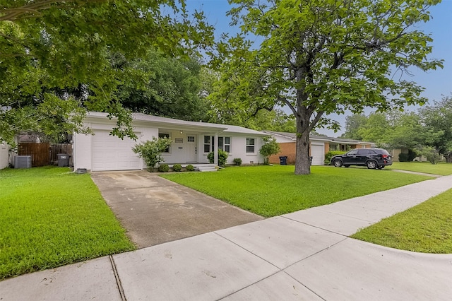 ranch-style home with an attached garage, driveway, and a front lawn