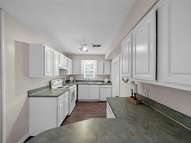1227 W Walker St, Denison, TX 75020 - kitchen with visible vents, dark countertops, a sink, and white appliances