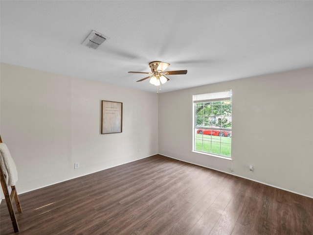 1227 W Walker St, Denison, TX 75020 - empty room featuring visible vents, a ceiling fan, and dark wood-style flooring