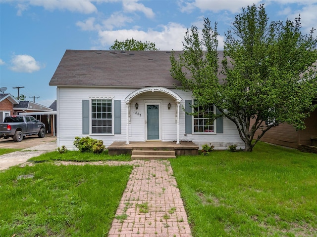 1227 W Walker St, Denison, TX 75020 - view of front of property featuring covered porch, a shingled roof, and a front lawn