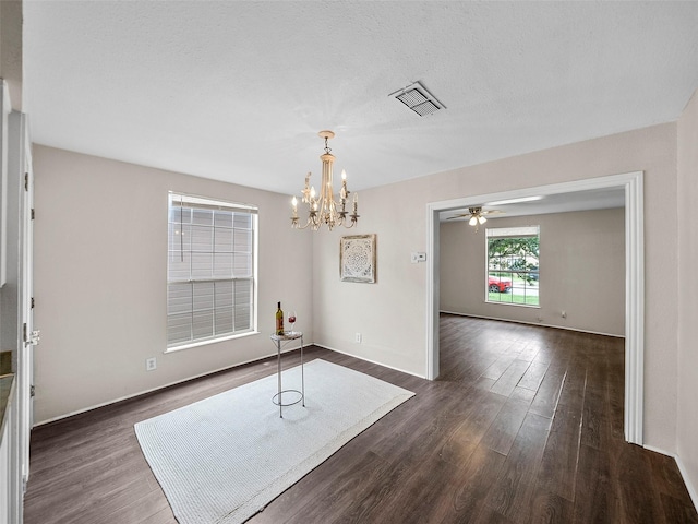 1227 W Walker St, Denison, TX 75020 - unfurnished dining area with visible vents, baseboards, ceiling fan with notable chandelier, and dark wood-style floors