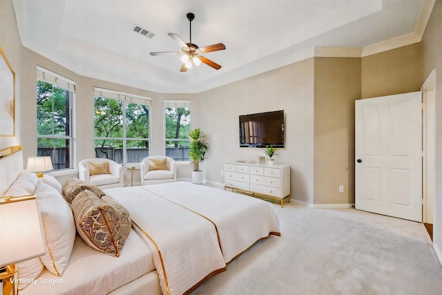 carpeted bedroom with a raised ceiling, ornamental molding, baseboards, and visible vents