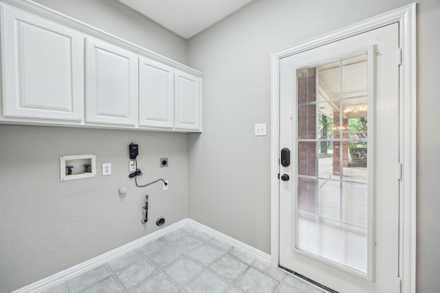 laundry area featuring baseboards, hookup for a washing machine, gas dryer hookup, electric dryer hookup, and cabinet space