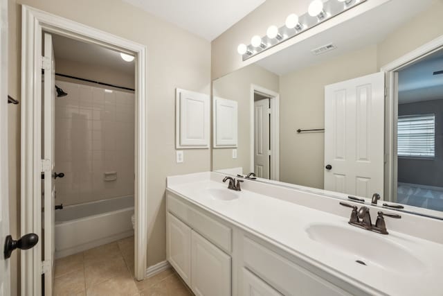 bathroom featuring double vanity, tile patterned floors, visible vents, and a sink