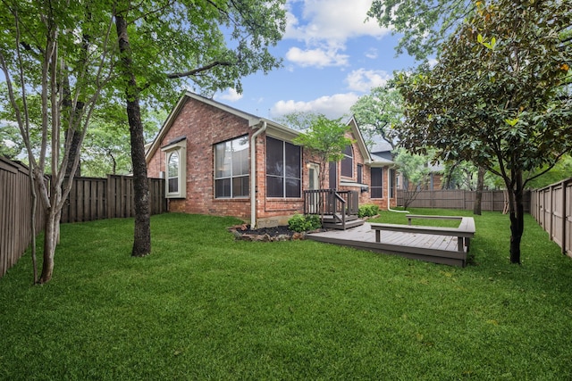 view of yard with a fenced backyard and a wooden deck