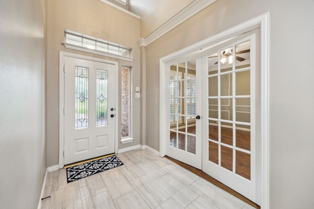 foyer entrance featuring french doors, baseboards, and ceiling fan