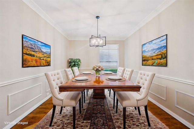 dining area featuring an inviting chandelier, crown molding, a decorative wall, and wood finished floors