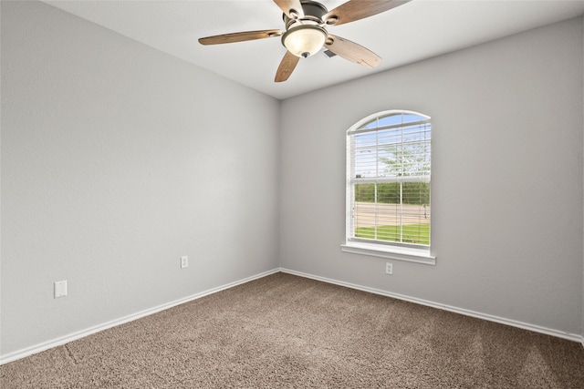 spare room featuring carpet floors, ceiling fan, and baseboards