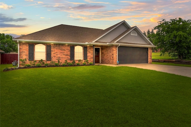 ranch-style house featuring fence, brick siding, a garage, concrete driveway, and a lawn