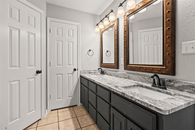 full bath featuring tile patterned flooring, a sink, and double vanity