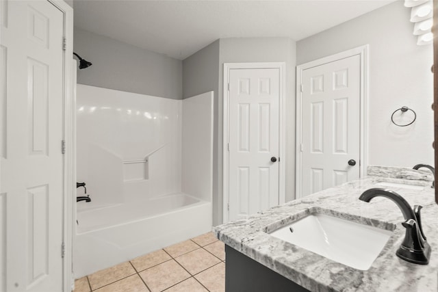 bathroom featuring tile patterned flooring, a sink, double vanity, and bathing tub / shower combination