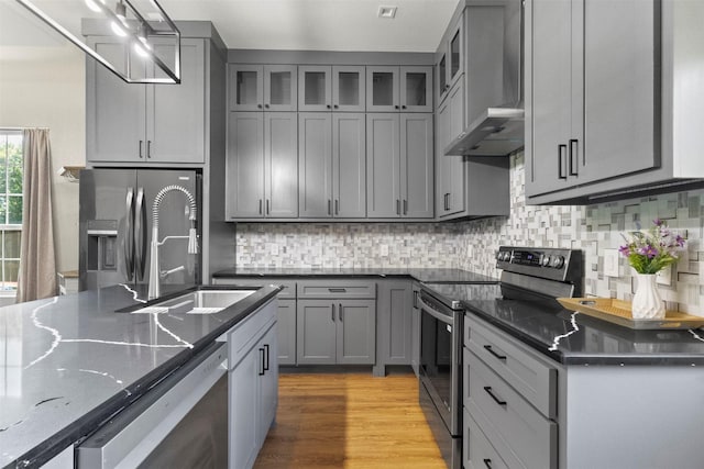 408 Bethlehem St, Terrell, TX 75160 - kitchen featuring stainless steel appliances, gray cabinetry, and wall chimney range hood