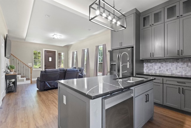 408 Bethlehem St, Terrell, TX 75160 - kitchen with gray cabinetry, wood finished floors, tasteful backsplash, and a sink