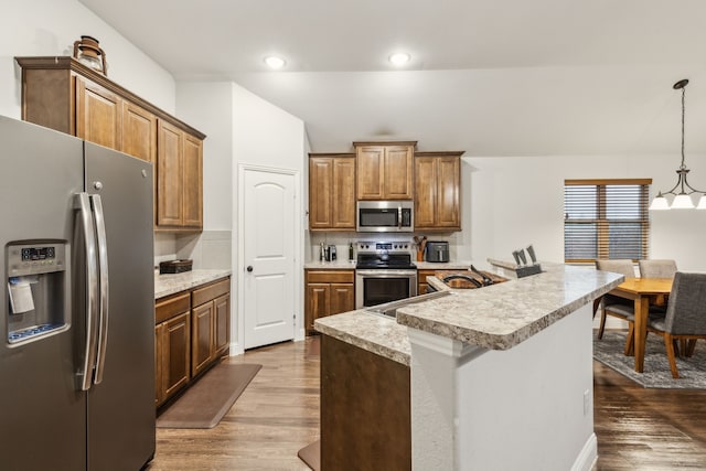 417 Highmeadow Dr, Aubrey, TX 76227 - kitchen with light countertops, appliances with stainless steel finishes, a notable chandelier, and dark wood-style floors
