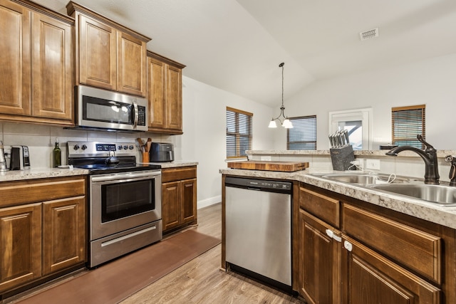 417 Highmeadow Dr, Aubrey, TX 76227 - kitchen featuring visible vents, lofted ceiling, light wood-style floors, a sink, and appliances with stainless steel finishes
