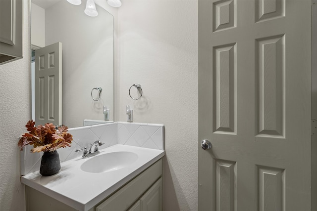 bathroom with vanity and tasteful backsplash