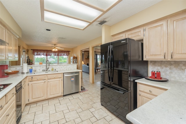 kitchen featuring tasteful backsplash, a sink, black appliances, and light brown cabinets