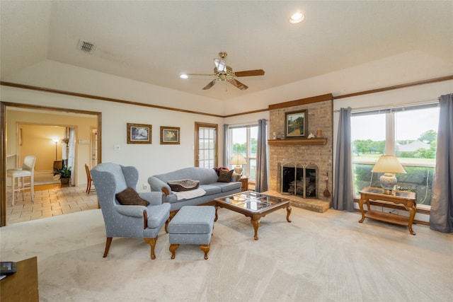 carpeted living room with a ceiling fan, visible vents, a healthy amount of sunlight, and a fireplace