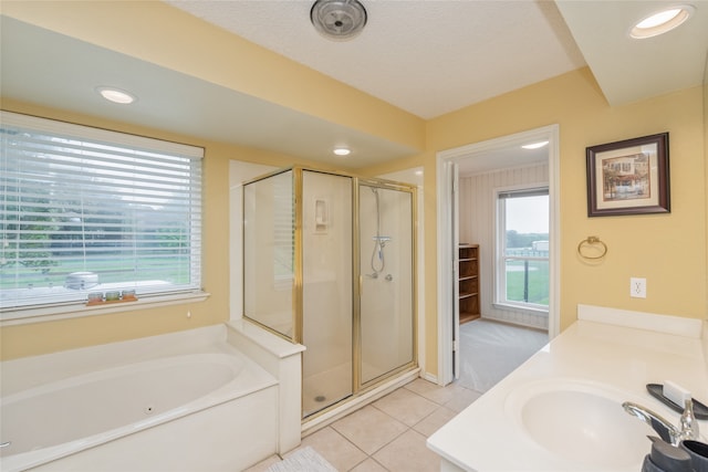 full bath with tile patterned floors, a wealth of natural light, a garden tub, and a stall shower