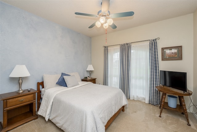 bedroom with a ceiling fan and carpet flooring