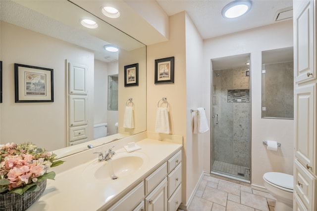 full bath featuring vanity, toilet, baseboards, and a stall shower
