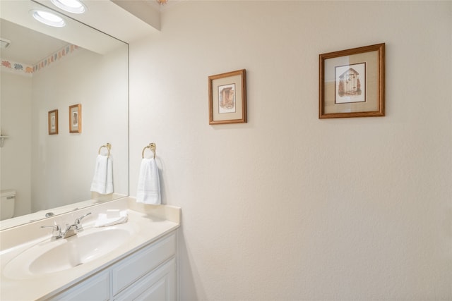bathroom with vanity and toilet