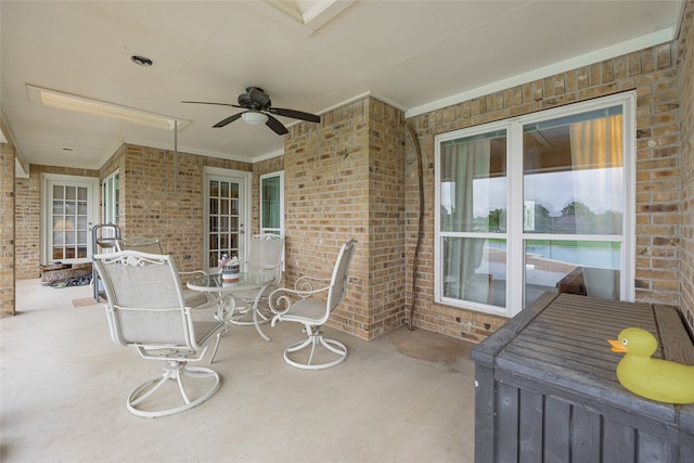 view of patio / terrace with outdoor dining area and a ceiling fan