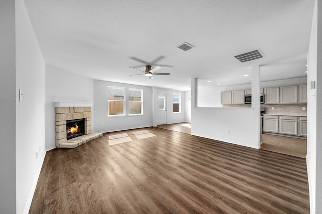13029 Guerin Dr, Frisco, TX 75035 - unfurnished living room featuring a ceiling fan, wood finished floors, and visible vents