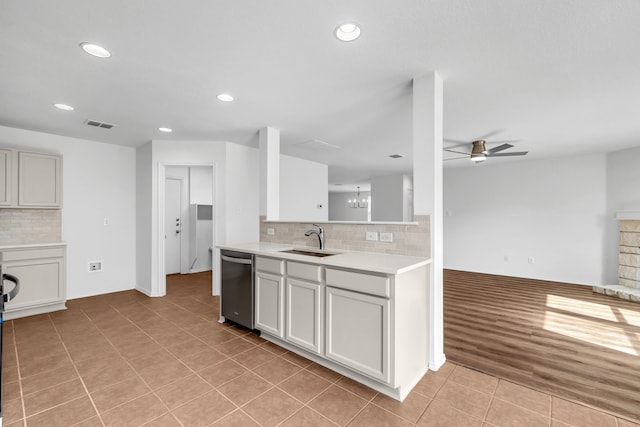 13029 Guerin Dr, Frisco, TX 75035 - kitchen with decorative backsplash, a ceiling fan, stainless steel dishwasher, a sink, and light tile patterned floors