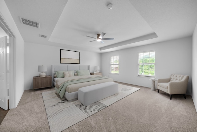 13029 Guerin Dr, Frisco, TX 75035 - carpeted bedroom featuring a ceiling fan, a tray ceiling, visible vents, and baseboards