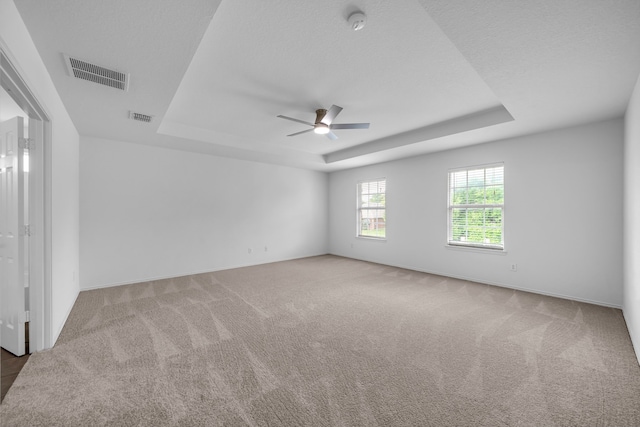 13029 Guerin Dr, Frisco, TX 75035 - carpeted empty room featuring visible vents, a ceiling fan, baseboards, and a tray ceiling