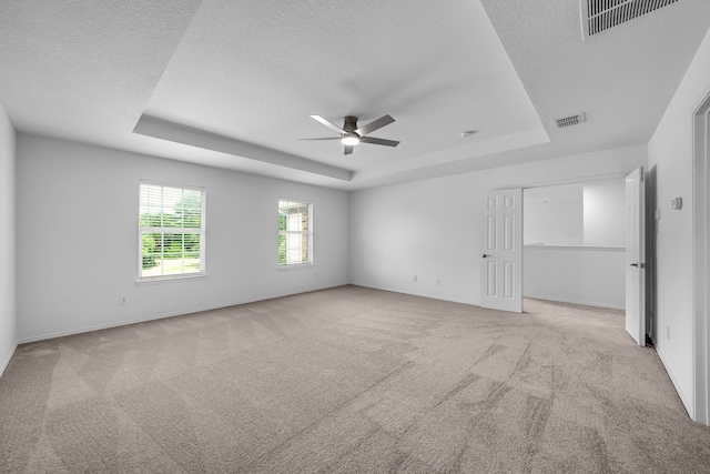 13029 Guerin Dr, Frisco, TX 75035 - unfurnished bedroom featuring a raised ceiling, a textured ceiling, carpet floors, and visible vents