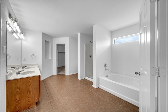 13029 Guerin Dr, Frisco, TX 75035 - bathroom with baseboards, a bath, tile patterned floors, a shower stall, and a sink