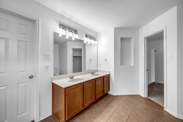 13029 Guerin Dr, Frisco, TX 75035 - full bathroom with a sink, tile patterned floors, double vanity, and a textured ceiling