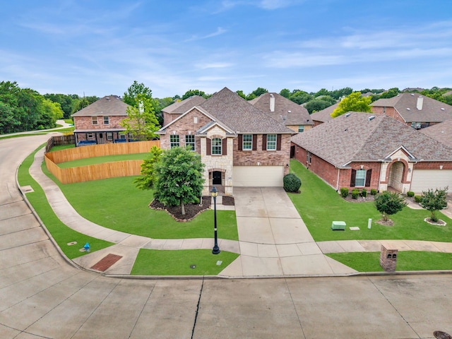 13029 Guerin Dr, Frisco, TX 75035 - traditional-style house featuring a garage, a front lawn, fence, stone siding, and driveway