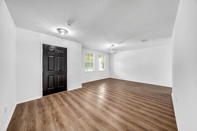 13029 Guerin Dr, Frisco, TX 75035 - foyer entrance with baseboards, a notable chandelier, wood finished floors, and visible vents