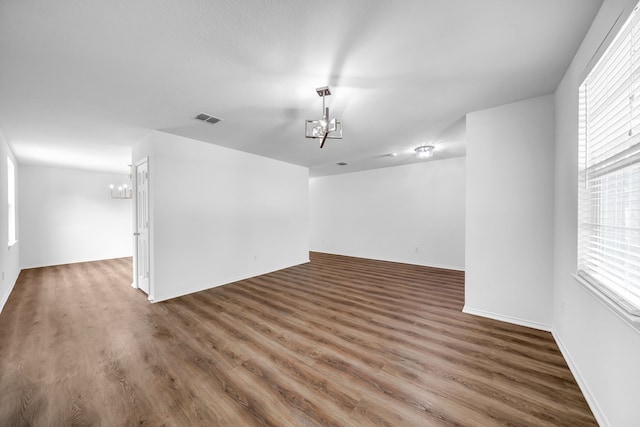 13029 Guerin Dr, Frisco, TX 75035 - unfurnished room with an inviting chandelier, wood finished floors, and visible vents