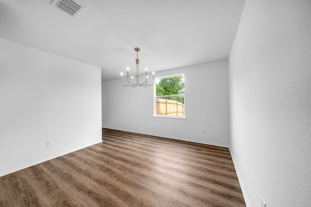 13029 Guerin Dr, Frisco, TX 75035 - empty room with baseboards, a notable chandelier, dark wood finished floors, and visible vents