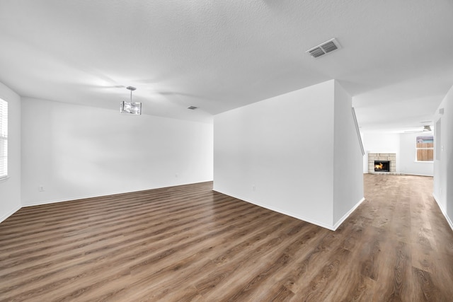 13029 Guerin Dr, Frisco, TX 75035 - interior space featuring visible vents, baseboards, wood finished floors, and a lit fireplace