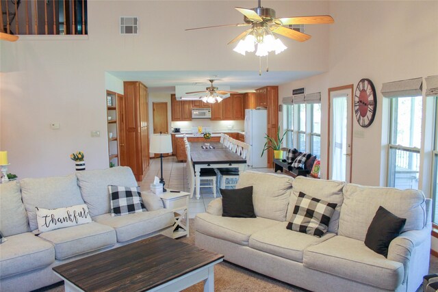 6928 Scott St, Eustace, TX 75124 - living room with a towering ceiling, plenty of natural light, and a ceiling fan