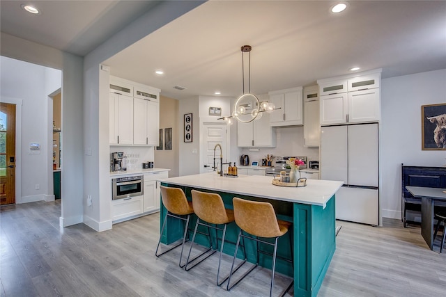 kitchen featuring light countertops, a sink, white cabinets, and stainless steel appliances