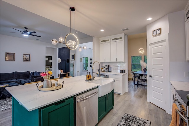 kitchen with stainless steel appliances, light wood-type flooring, white cabinetry, and visible vents