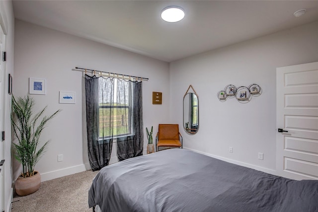 bedroom with baseboards and carpet flooring
